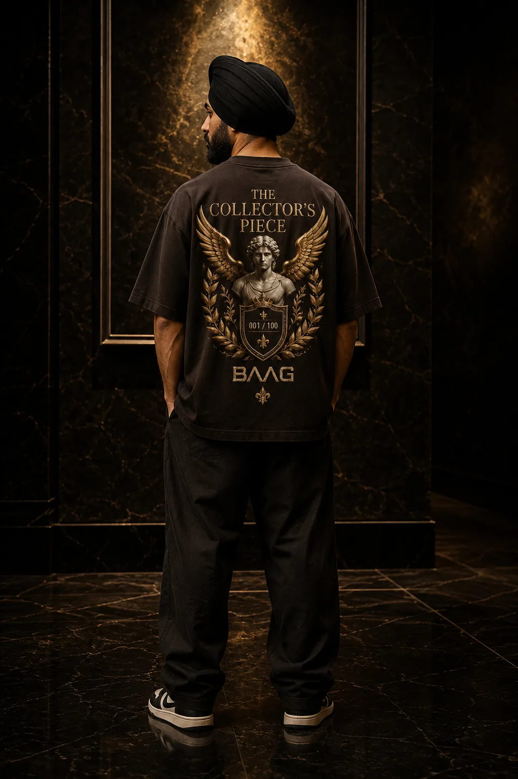 Sikh model wearing the dark BAAG Collector's Piece oversized T-shirt with antique-gold artwork
